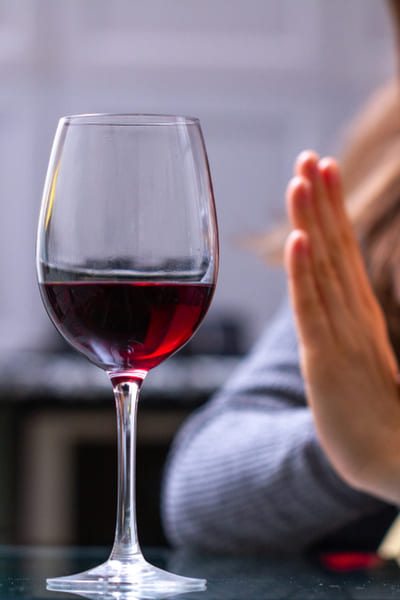 Руки крестом перед бокалом с вином